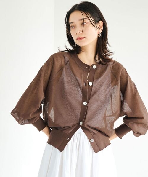 ノースリーブにカーディガンを羽織った女性