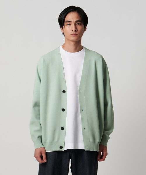 ライムグリーンのカーディガンを着た男性