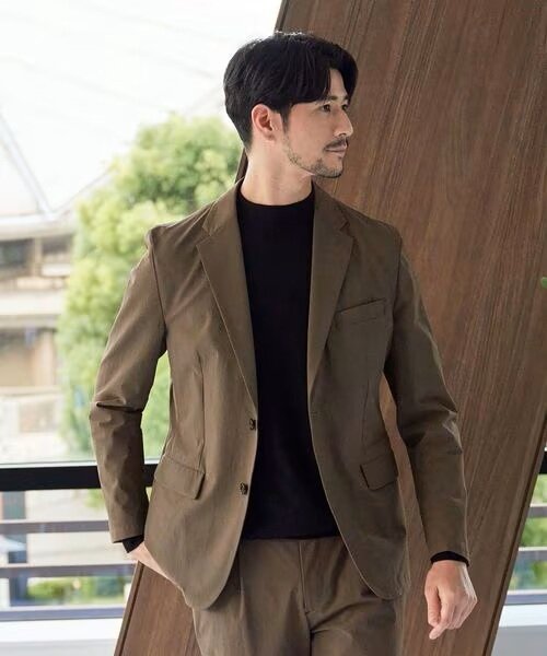 モカのジャケットを羽織っている男性