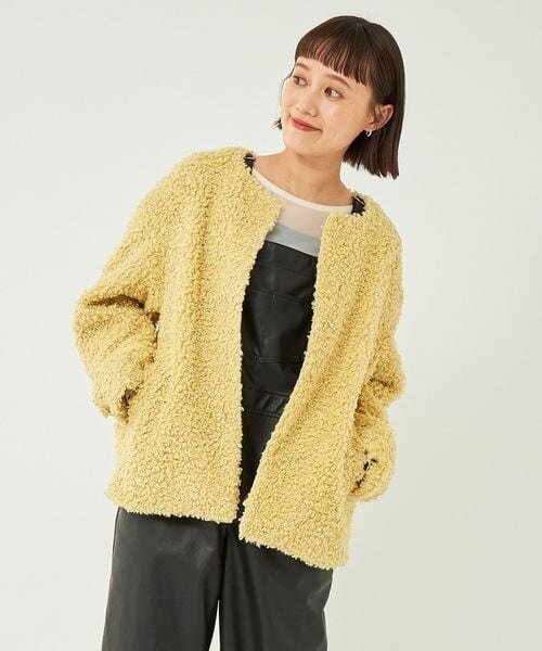 ノーカラーボアブルゾンを着た女性