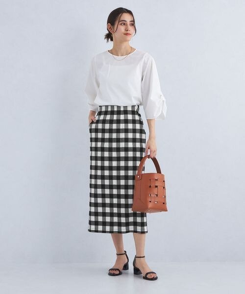 チェック柄のタイトスカートを着た女性