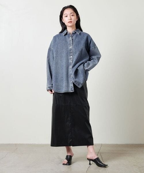 オーバーサイズのデニムシャツを着た女性