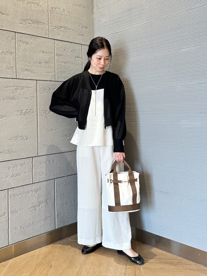 黒ニットとオールインワンを着た女性