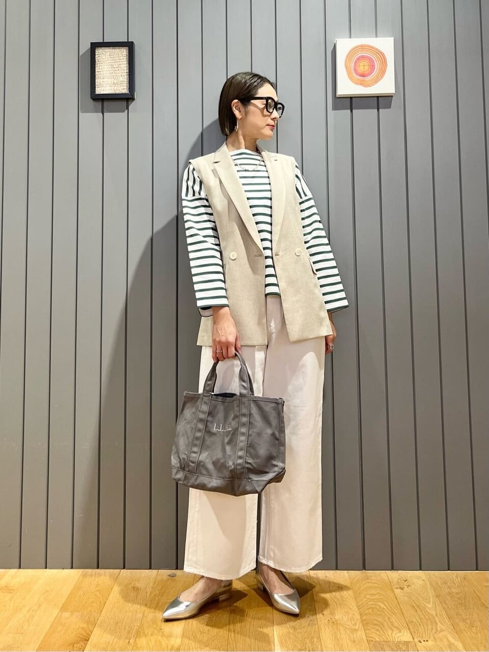 ボーダーカットソーとジレを着た女性