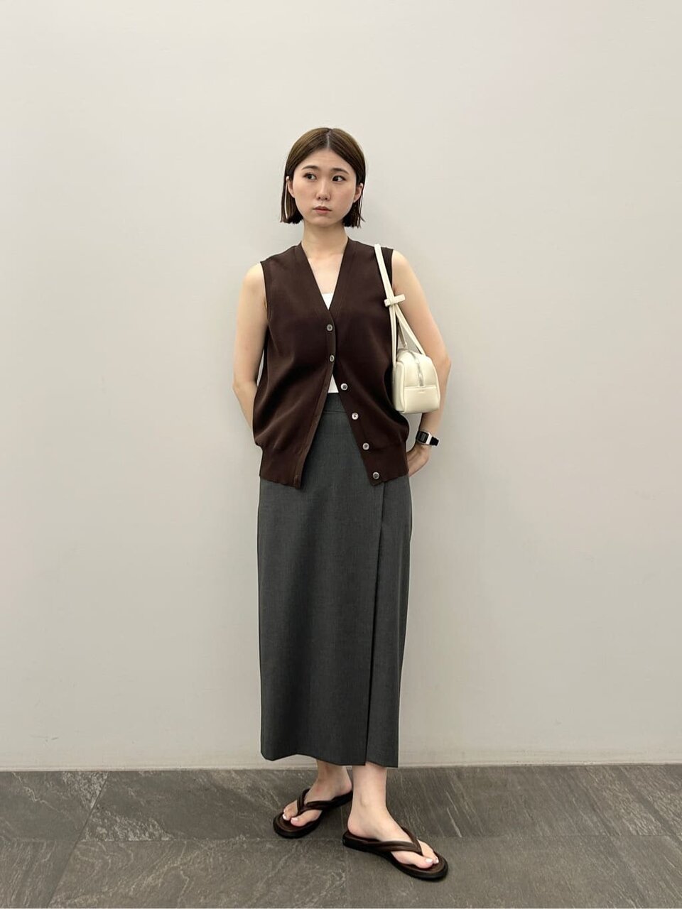 ダークブラウンのベスト×ダークグレーのラップスカートのコーデ
