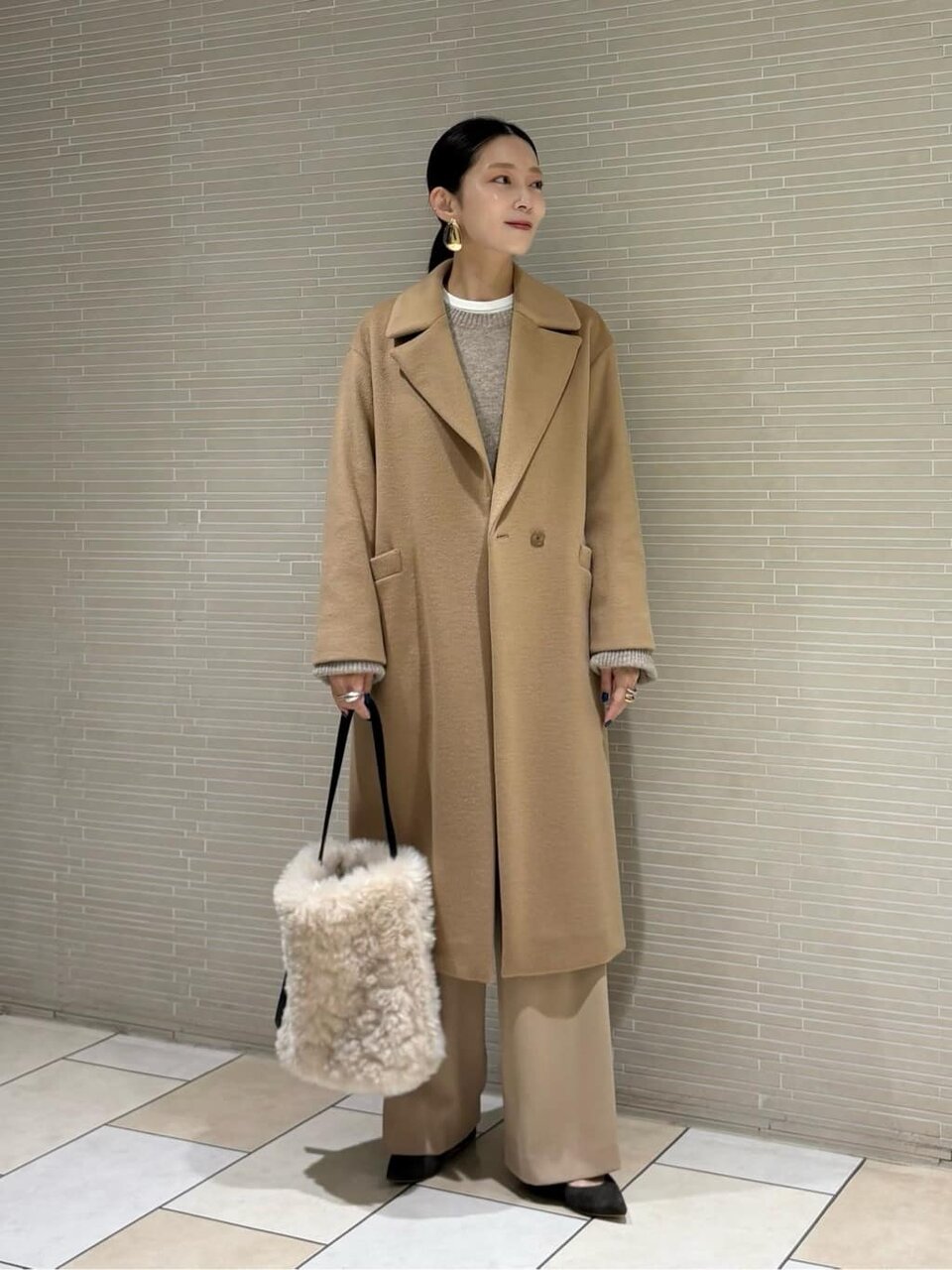 ロングコートとチノパンコーデの女性