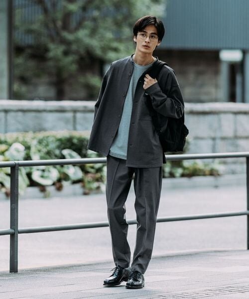 グレーのジャケットとパンツを着た男性