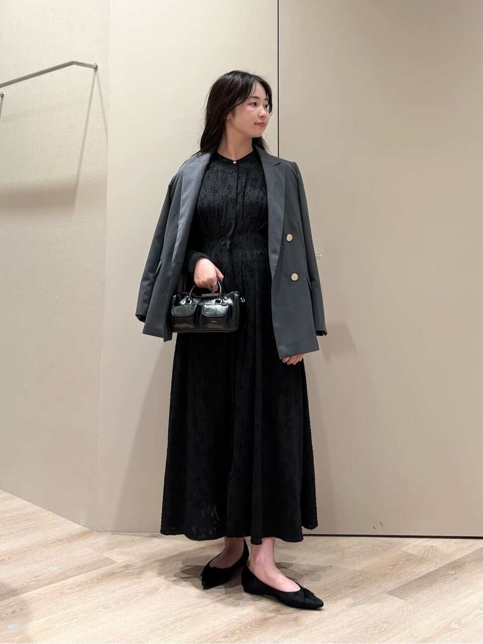 黒のワンピースにダークグレーのジャケットをあわせたコーデ
