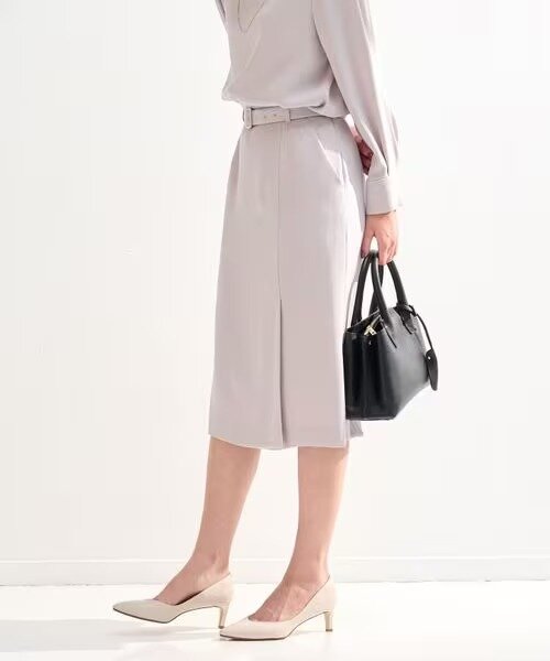 ライトグレーのスカートをはいた女性