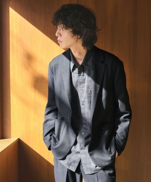 スーツにチェックシャツを着た男性