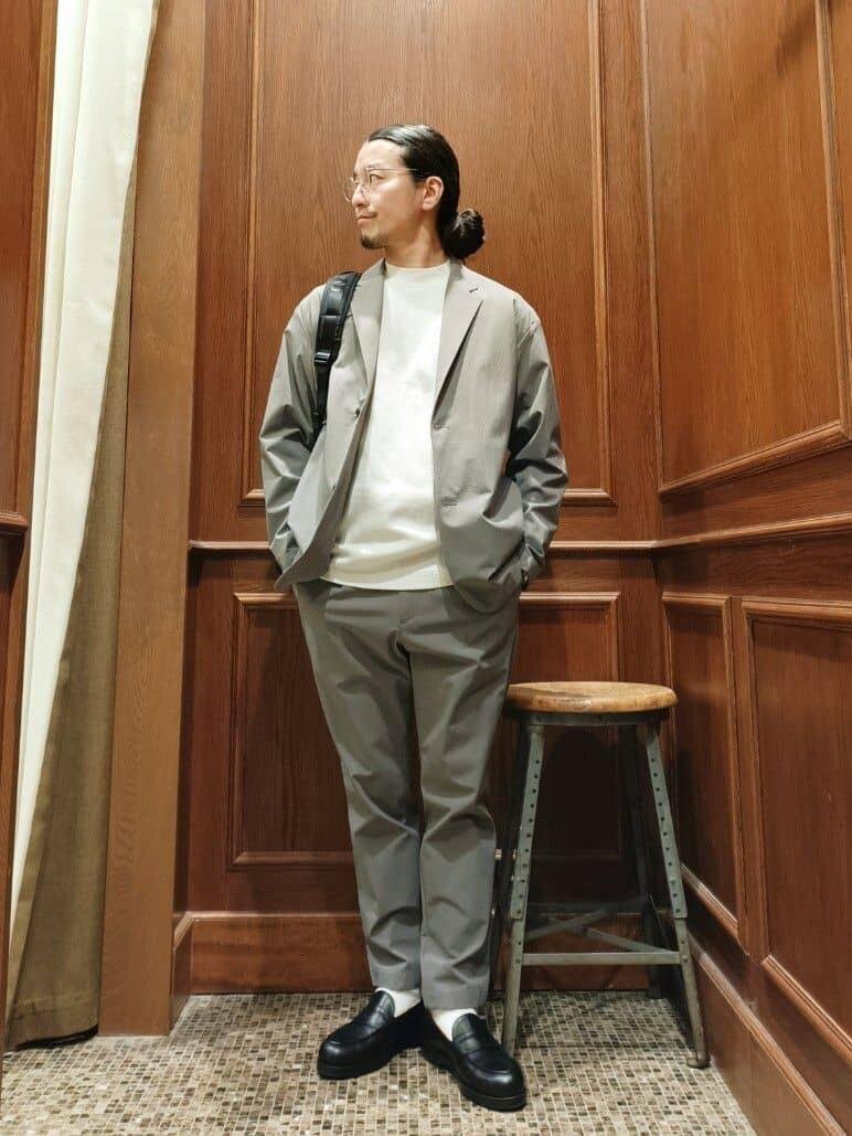 グレーのセットアップコーデを着ている男性