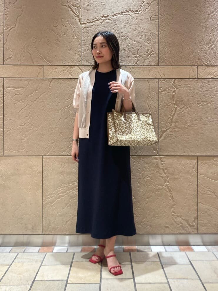 シアー素材のカーディガンとワンピースを着た女性