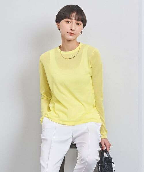 黄色いシアーニットを着た女性