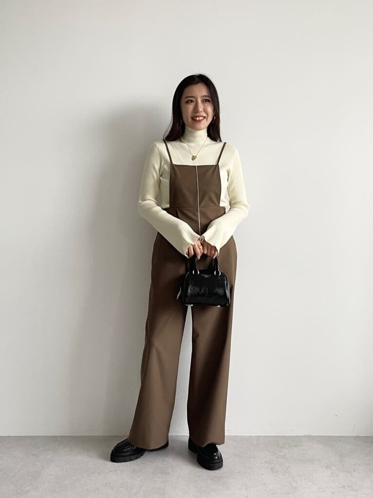 茶色のサロペットを着た女性