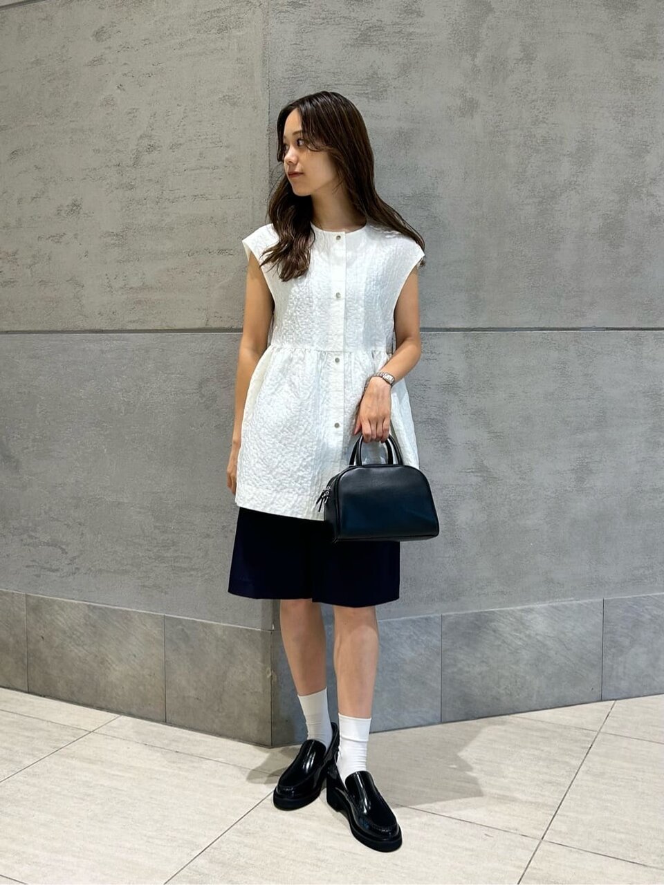 白いブラウスとショートパンツを着た女性