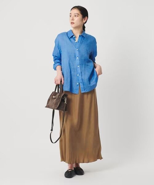 ゆとりのあるサイズ感のマーメイドスカートをはいた女性