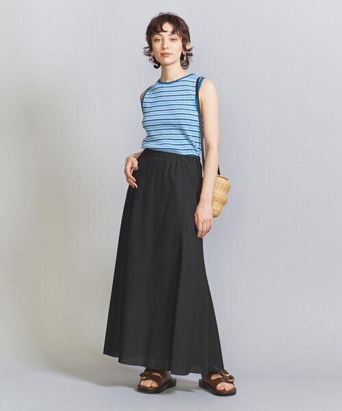 黒のフレアスカートとノースリーブトップスのコーデ