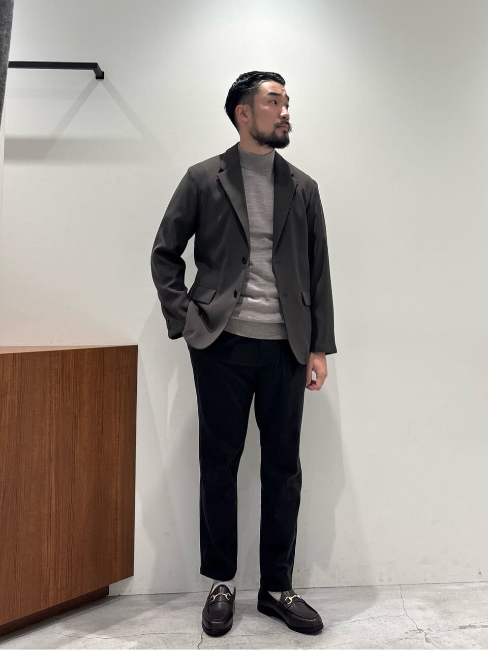 テーラードジャケットとイージーパンツを着た男性