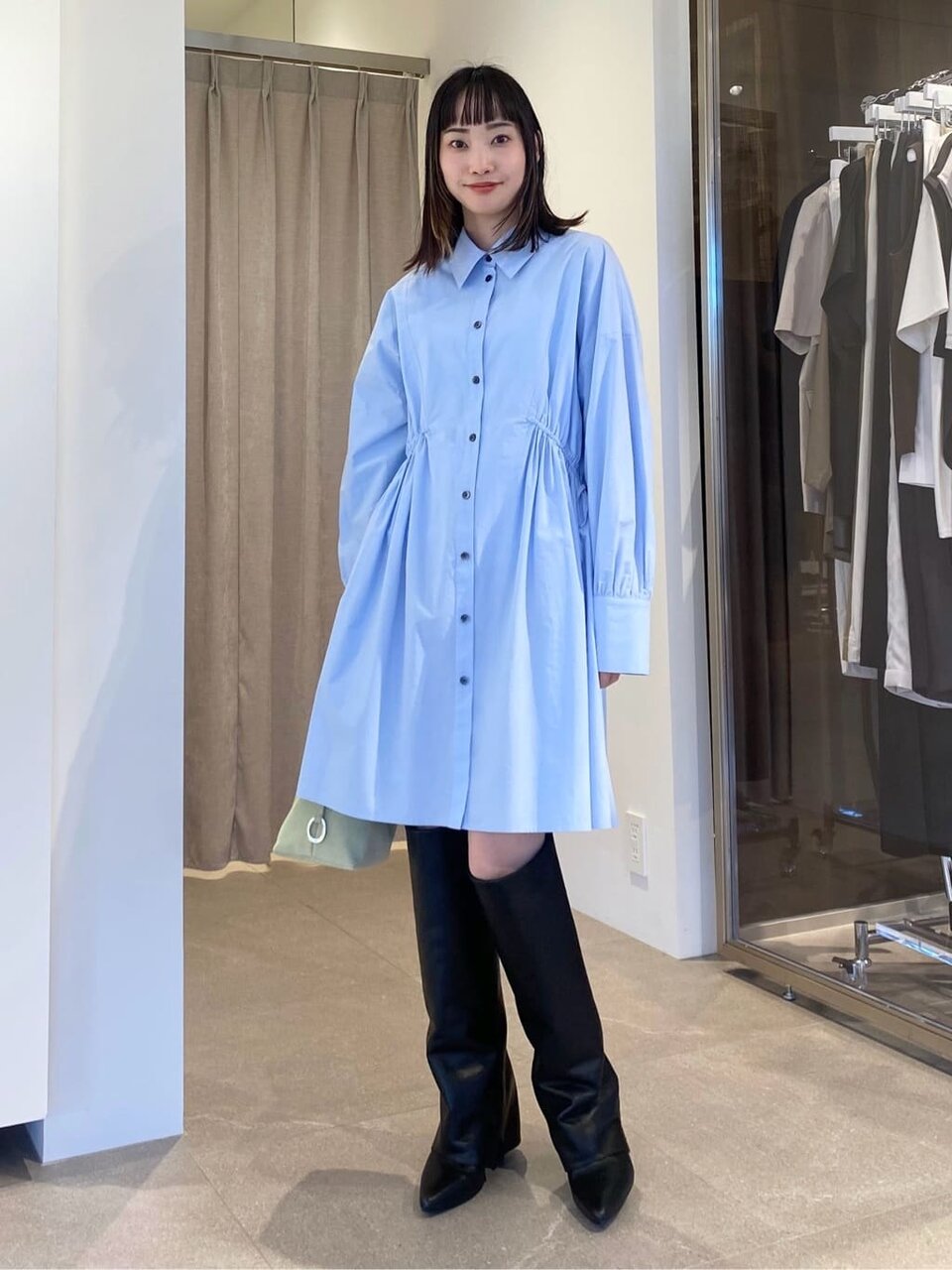 ブルーのシャツワンピースを着た女性