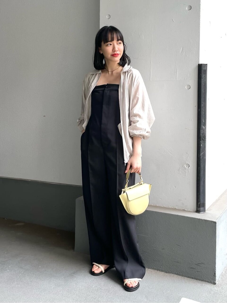 ラッフルカラーシャツと白のパンツを着た女性