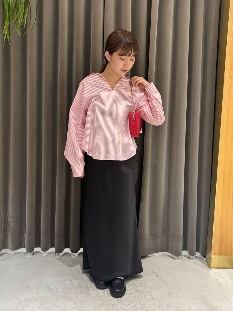 ストライプ柄シャツとマーメイドスカートを着た女性