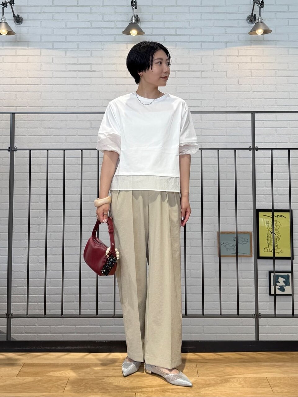 ボリュームスリーブカットソーとワイドパンツを着た女性