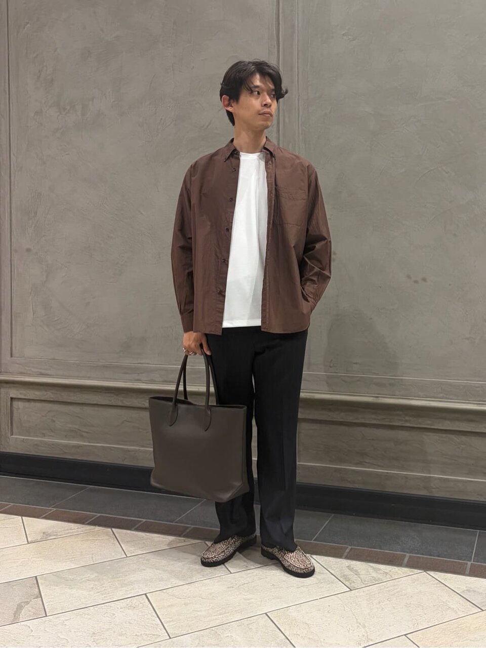 ボタンダウンシャツとスラックスを着た男性