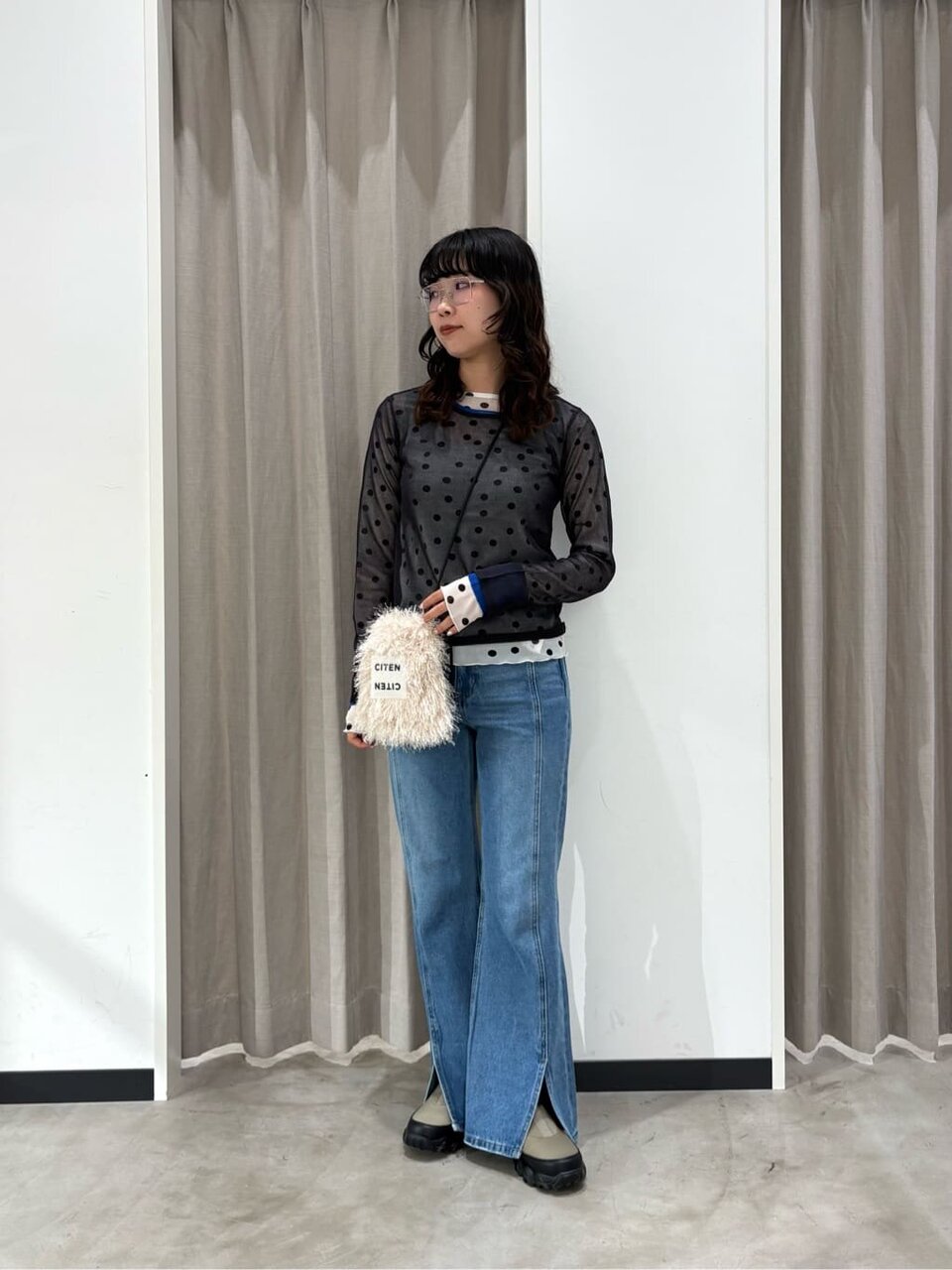 シアートップスをレイヤードした女性
